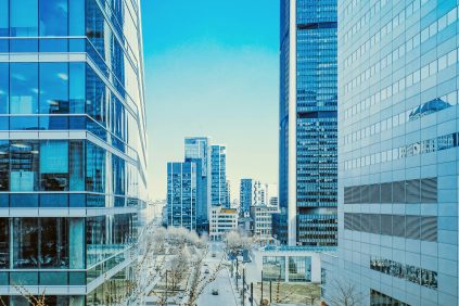 a city street lined with tall buildings next to each other